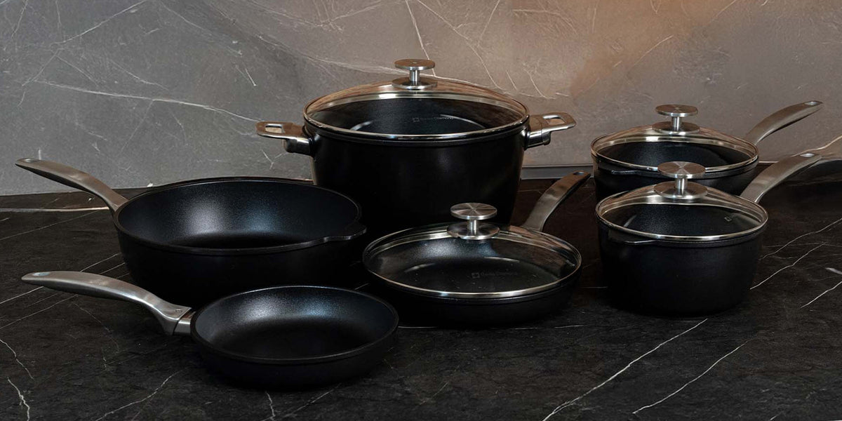 Swiss Diamond CXD ceramic cookware set on a marble counter